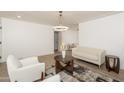 Bright living room with modern chandelier, neutral furniture and open floor plan at 4307 E Turney Ave, Phoenix, AZ 85018