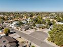 Wide aerial view of a suburban neighborhood showcasing tree-lined streets and mountain views at 4702 E Monte Cristo Ave, Phoenix, AZ 85032