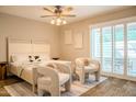 Cozy bedroom featuring neutral tones, a comfortable bed, and natural light from the sliding door at 5100 N Miller Rd # 24, Scottsdale, AZ 85250