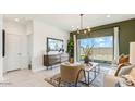 Comfortable living room featuring a modern design, cozy seating, and a sliding door that provides seamless indoor-outdoor living at 5573 E Rock Bush Ln, San Tan Valley, AZ 85140