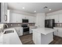 Modern kitchen featuring white cabinets, a center island, and stainless steel appliances at 9303 E Static Ave, Mesa, AZ 85212