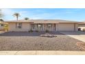 Single-story home with desert landscaping, covered front porch, and an attached two-car garage at 9817 W Loma Blanca Dr, Sun City, AZ 85351