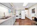 Bright kitchen with modern appliances, light gray cabinets, wood floors, and a skylight for plenty of natural light at 9834 W Evergreen Dr, Sun City, AZ 85373