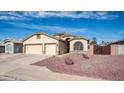 Beautiful home with a large driveway, two-car garage, and desert landscaping at 11460 E Dartmouth St, Mesa, AZ 85207