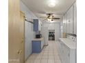 Functional laundry room has lots of storage and counter space at 12434 W Fieldstone Dr, Sun City West, AZ 85375