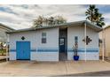 Charming mobile home features light blue trim, an attached garage, and a front porch entrance at 17200 W Bell Rd # 26, Surprise, AZ 85374