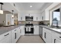 Well-lit kitchen with white cabinetry, stainless steel appliances, and stone countertops at 1725 N Date -- # 23, Mesa, AZ 85201