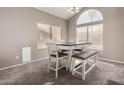 Dining area with modern table and chairs, plus large windows at 1865 E Pinto Dr, Gilbert, AZ 85296