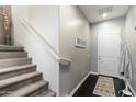 Inviting entryway with a staircase, coat rack, and dark wood-look flooring at 23065 N 75Th St, Scottsdale, AZ 85255