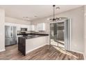 Modern kitchen with stainless steel appliances, white cabinets, dark countertops, and sliding glass door to the outside at 2402 E 5Th St # 1403, Tempe, AZ 85288