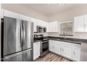 Well-equipped kitchen with stainless steel appliances, ample white cabinetry, and dark countertops at 2402 E 5Th St # 1403, Tempe, AZ 85288