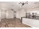 Open-concept living space features hard surface flooring, a ceiling fan, and a view of the kitchen at 2402 E 5Th St # 1403, Tempe, AZ 85288