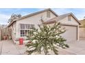 Charming one-story home featuring an attached one car garage, desert landscaping, and mature trees at 3147 E Michigan Ave, Phoenix, AZ 85032