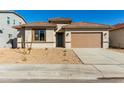 Charming single-story home with a well-maintained yard and a two-car garage on a sunny day at 31541 N Wet Creek Rd, San Tan Valley, AZ 85143