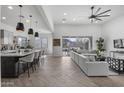 Open-concept kitchen and living area with herringbone floors and mountain views at 3539 E Starflower Dr, Queen Creek, AZ 85142