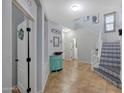 Welcoming foyer with tile floors, staircase with decorative risers, and bright, neutral walls at 3553 N 292Nd Dr, Buckeye, AZ 85396