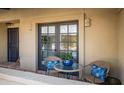 Cozy outdoor seating area with wicker chairs and a glass table, perfect for enjoying relaxing moments at 37206 N Tom Darlington Dr # 13, Carefree, AZ 85377