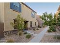 Inviting home exterior with desert landscaping, blue shutters and neutral colors creating curb appeal at 3911 S 79Th Ln, Phoenix, AZ 85043