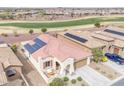 A high angle view of a well-kept home with solar panels, landscaped yard, and golf course views at 3956 N San Marin Dr, Florence, AZ 85132