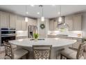 Modern kitchen with a large center island, stainless steel appliances, and a stylish range hood at 4107 N Hawthorn Dr, Florence, AZ 85132