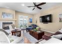 Bright and airy living room with a fireplace, ceiling fan, and access to the backyard at 4217 E Edgemont Ave, Phoenix, AZ 85008