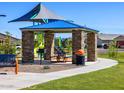 Covered picnic area with stone pillars, picnic table, playground and trash receptacle at 4354 W Jeanette Ln, San Tan Valley, AZ 85144