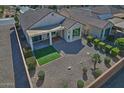 Aerial view of backyard featuring covered patio, synthetic grass, and low maintenance desert landscaping at 4424 N Potomac Dr, Florence, AZ 85132