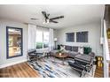 Bright living room with a comfortable gray sofa, decorative pillows, and a large window with natural light at 5094 N 83Rd St, Scottsdale, AZ 85250