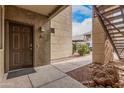 Exterior view of the entrance to unit 114 near stairs, landscaping, and a walkway at 5303 N 7Th St # 114, Phoenix, AZ 85014