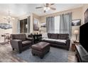 Inviting living room with leather seating, ceiling fan, and sliding glass door to the outside at 5303 N 7Th St # 114, Phoenix, AZ 85014