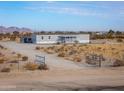 Exterior of single-story home with desert landscaping and fenced perimeter at 53974 W Barrel Rd, Maricopa, AZ 85139