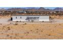 View of single-story home with a porch, fenced yard, and desert landscaping at 53974 W Barrel Rd, Maricopa, AZ 85139