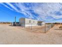 View of single-story home with a fenced yard and desert landscaping at 53974 W Barrel Rd, Maricopa, AZ 85139