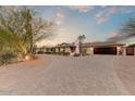 Wide brick driveway approaching house, flanked by desert landscaping at 6323 E Gold Dust Ave, Paradise Valley, AZ 85253