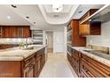 Traditional-style kitchen with wood cabinets, stainless steel appliances, and tile backsplash at 6323 E Gold Dust Ave, Paradise Valley, AZ 85253