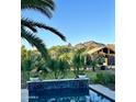 Inviting backyard pool with desert landscaping, mountain views, and a charming pergola-covered patio area at 6323 E Gold Dust Ave, Paradise Valley, AZ 85253