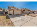 View of a two-story home with a wide driveway and a brick-trimmed, two-car garage in a residential neighborhood at 6405 W Saguaro Dr, Glendale, AZ 85304