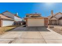 Two-story home showcasing a two-car garage with brick trim, set in a residential neighborhood on a sunny day at 6405 W Saguaro Dr, Glendale, AZ 85304