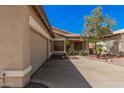 Beige single-story home with tile roof, concrete driveway, attached two-car garage and desert landscaping at 6640 W Honeysuckle Dr, Phoenix, AZ 85083