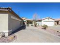 Charming home with a spacious driveway, dual garages, attractive desert landscaping, and a manicured front yard at 6640 W Honeysuckle Dr, Phoenix, AZ 85083