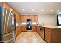 Modern kitchen featuring stainless steel appliances, granite countertops, and ample cabinet space at 7609 W Whitehorn Trl, Peoria, AZ 85383