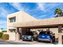 Beige two story condo with a two car covered parking and landscaped yard under a sunny blue sky at 7830 E Park View Dr, Mesa, AZ 85208