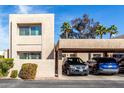 Beige two story condo with a two car covered parking and landscaped yard under a sunny blue sky at 7830 E Park View Dr, Mesa, AZ 85208