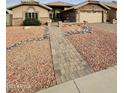 Inviting front exterior with a brick walkway leading to the entrance and well-maintained landscaping with decorative rock at 8536 W Rockwood Dr, Peoria, AZ 85382