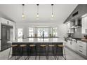 A spacious kitchen featuring an oversized island with a breakfast bar and modern appliances at 9505 S Kenneth Pl, Tempe, AZ 85284