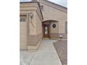 Inviting home entrance with a covered walkway and an oval glass paneled front door at 10323 W Carousel Dr, Arizona City, AZ 85123