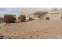 Single-story home featuring desert landscaping with decorative retaining wall at 11184 W Royal Palm Rd, Peoria, AZ 85345