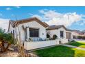 Beautiful single-story home with desert landscaping, lush green lawn, and a cozy front patio at 11307 E Ellis St, Mesa, AZ 85207