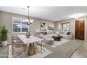 Bright living room featuring a dining area, a comfortable sofa, and neutral tones at 123 W Sweet Shrub Ave, San Tan Valley, AZ 85140