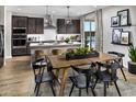 Modern kitchen featuring stainless steel appliances, an island with seating, and an adjacent dining area at 12551 W Parkway Ln, Avondale, AZ 85323